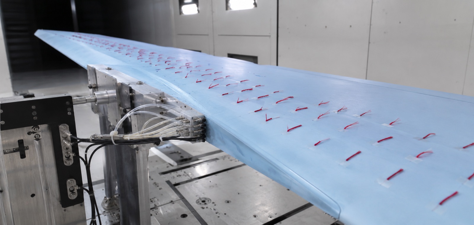 An aerofoil in a wind tunnel with flow tufts attached
